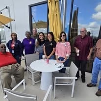 Kilgore Lions Club members at last year's Coat Drive, gathered around a table on a rooftop patio