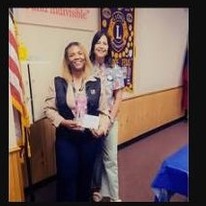 A Kilgore Lions Club member presenting a donation to a community partner